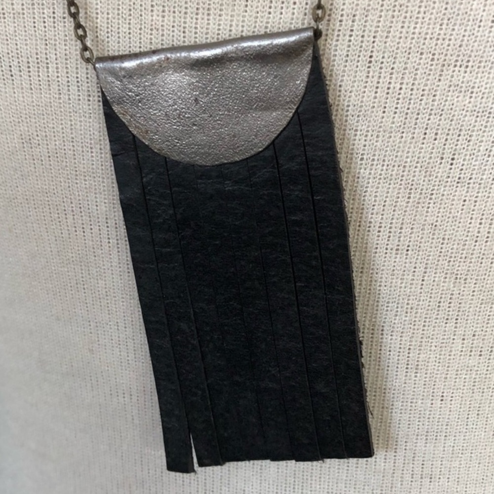 Black leather and silver long necklace.
